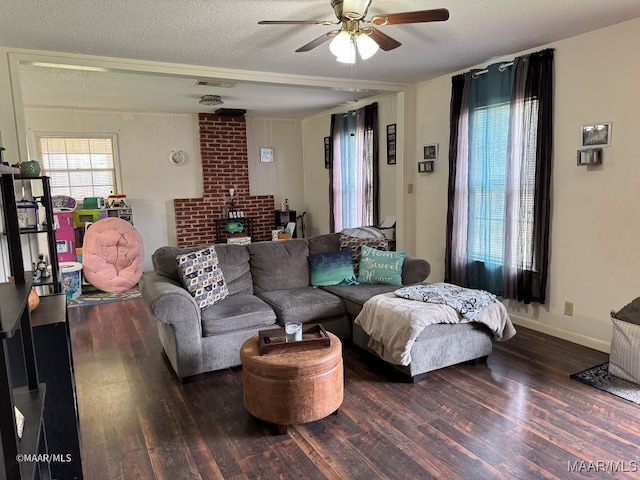 living room featuring a textured ceiling, ceiling fan, and dark hardwood / wood-style floors