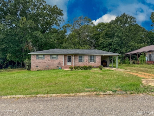 ranch-style house with a front lawn and a carport