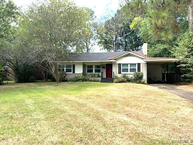 ranch-style home featuring a carport and a front yard