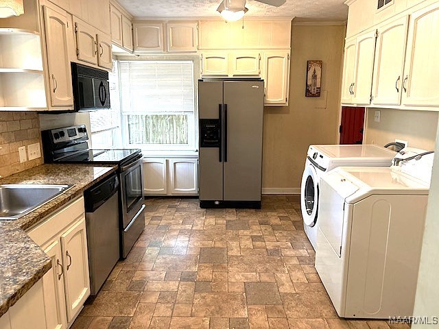 kitchen featuring cream cabinetry, appliances with stainless steel finishes, washing machine and clothes dryer, and ceiling fan