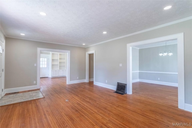 2056 Gorgas St, Montgomery, AL 36106 - unfurnished room with a chandelier, a textured ceiling, baseboards, and wood finished floors