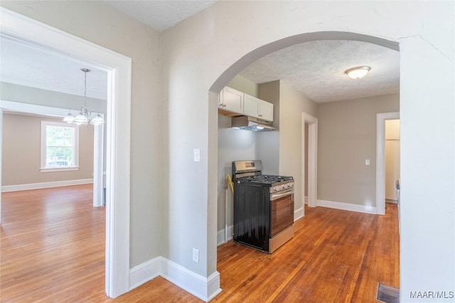 2056 Gorgas St, Montgomery, AL 36106 - hallway with arched walkways, visible vents, a textured ceiling, and light wood-type flooring