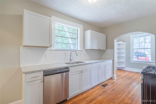 2056 Gorgas St, Montgomery, AL 36106 - kitchen with visible vents, backsplash, light wood-type flooring, stainless steel appliances, and a sink