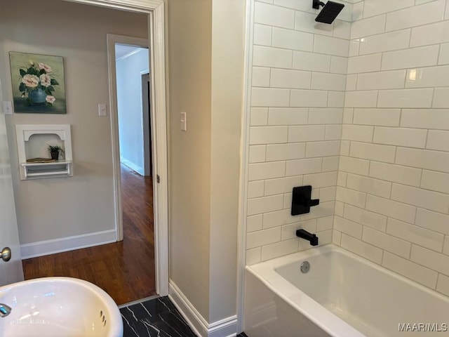 bathroom with shower / bathtub combination and baseboards