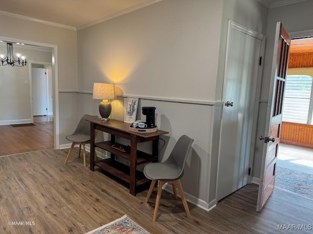 office area with a chandelier, wainscoting, crown molding, and wood finished floors