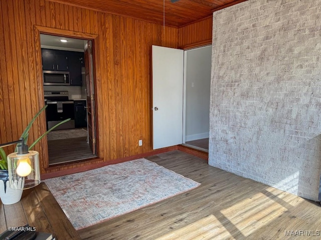 unfurnished room featuring wooden ceiling and wood finished floors