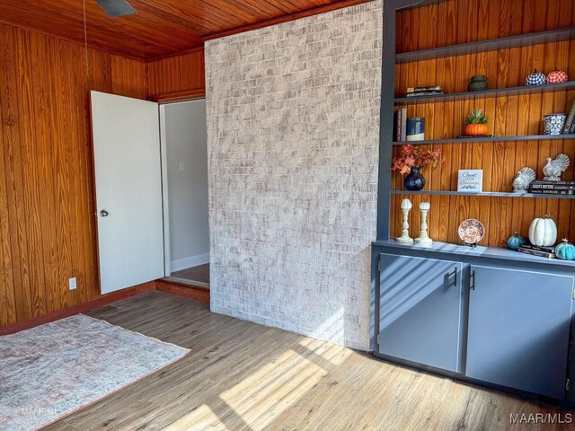 interior space featuring wooden walls, wood ceiling, and wood finished floors