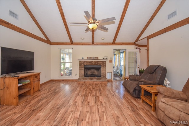 living room featuring a fireplace, high vaulted ceiling, light hardwood / wood-style flooring, ceiling fan, and beam ceiling