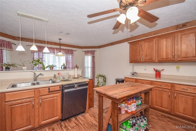 145 Cotton Ln, Deatsville, AL 36022 - kitchen with a sink, light wood finished floors, dishwasher, a textured ceiling, and visible vents