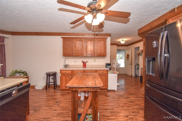 kitchen featuring stainless steel fridge, dark hardwood / wood-style floors, a textured ceiling, and ceiling fan