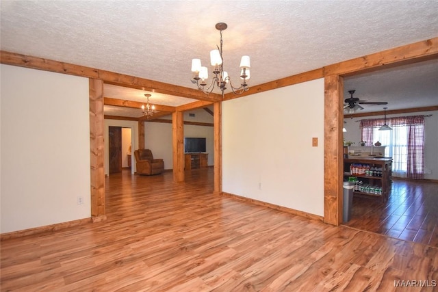 145 Cotton Ln, Deatsville, AL 36022 - spare room with baseboards, beam ceiling, a textured ceiling, and wood finished floors