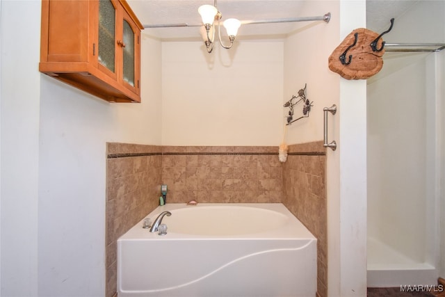 bathroom with a tub and a textured ceiling