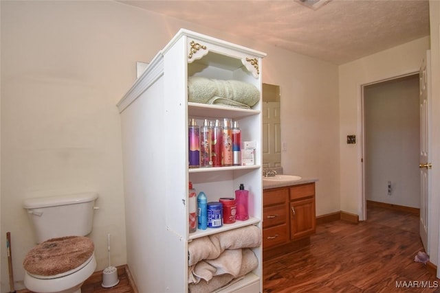 145 Cotton Ln, Deatsville, AL 36022 - bathroom with vanity, baseboards, wood finished floors, and toilet