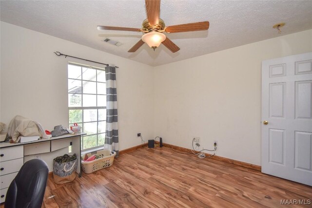 145 Cotton Ln, Deatsville, AL 36022 - home office featuring a textured ceiling, ceiling fan, wood finished floors, and visible vents