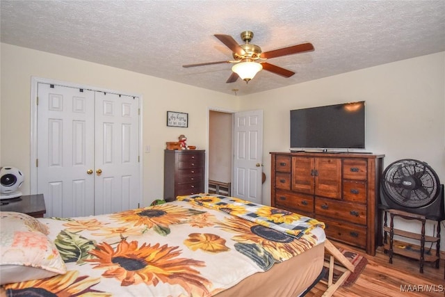 145 Cotton Ln, Deatsville, AL 36022 - bedroom with a textured ceiling, ceiling fan, wood finished floors, and a closet