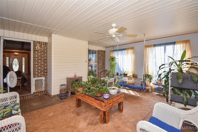 carpeted living room with ceiling fan