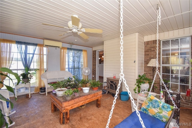 sunroom with plenty of natural light, ceiling fan, and a wall mounted air conditioner