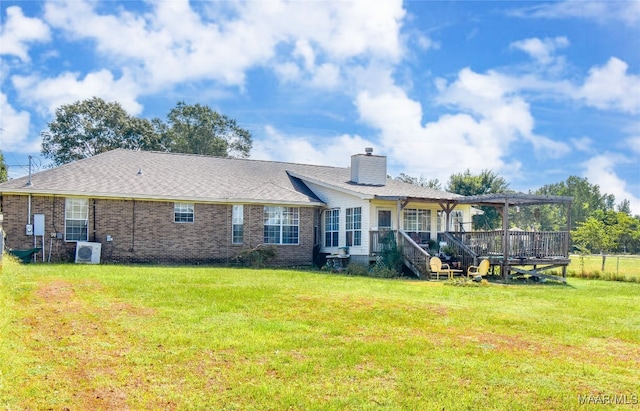 145 Cotton Ln, Deatsville, AL 36022 - back of property featuring a lawn, brick siding, a chimney, and a deck