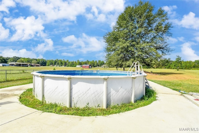 view of pool with a lawn