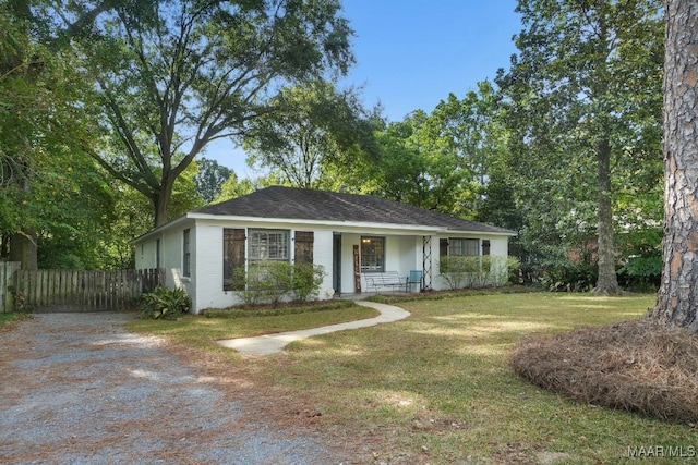 ranch-style house with a porch and a front yard