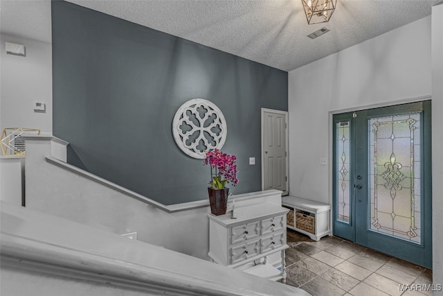 foyer featuring a textured ceiling