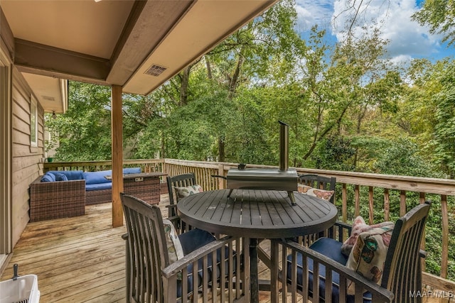 wooden deck with outdoor lounge area