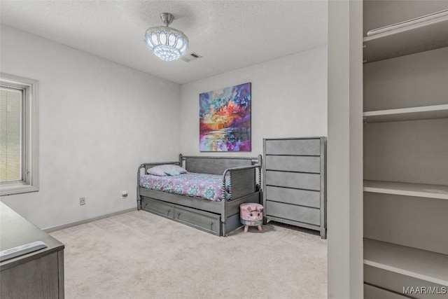 carpeted bedroom with a textured ceiling