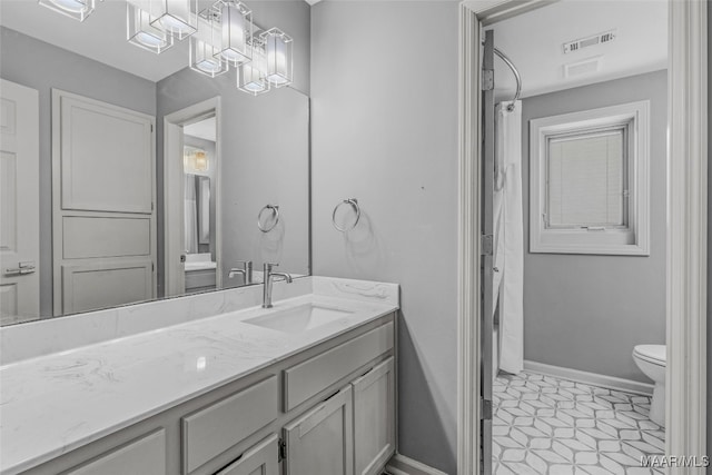 bathroom featuring vanity, toilet, and tile patterned floors