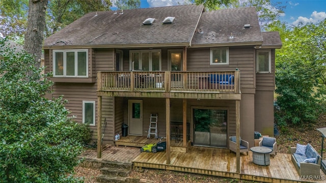 rear view of house with a wooden deck