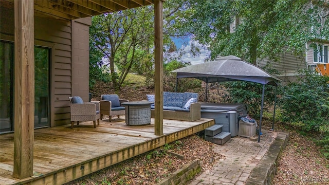 wooden deck featuring a hot tub, an outdoor hangout area, and a gazebo