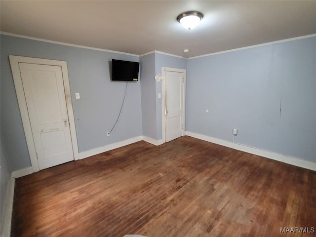 unfurnished room with ornamental molding and dark hardwood / wood-style flooring