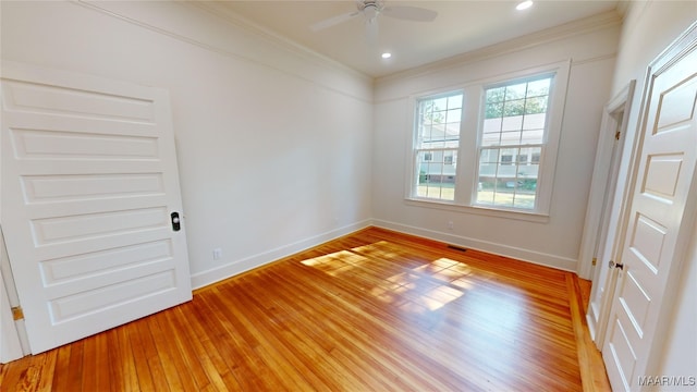 empty room featuring baseboards, a ceiling fan, and crown molding
