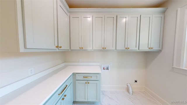 washroom featuring electric dryer hookup, cabinet space, marble finish floor, washer hookup, and baseboards