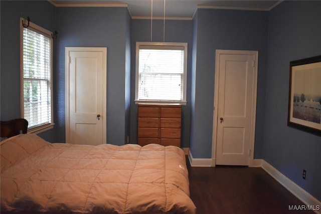 bedroom with dark wood-type flooring, multiple windows, and ornamental molding