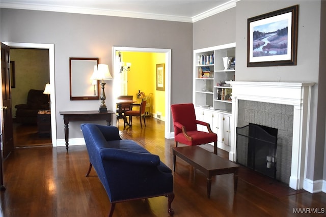 living area with ornamental molding and dark hardwood / wood-style floors