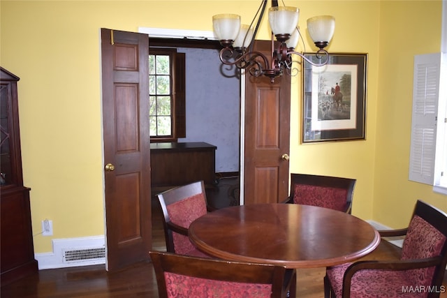 dining room with an inviting chandelier and dark hardwood / wood-style floors