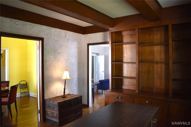 home office featuring beamed ceiling and wood-type flooring