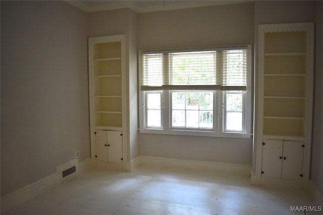 empty room featuring ornamental molding