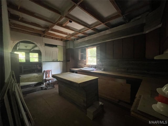 kitchen featuring beamed ceiling, plenty of natural light, sink, and coffered ceiling