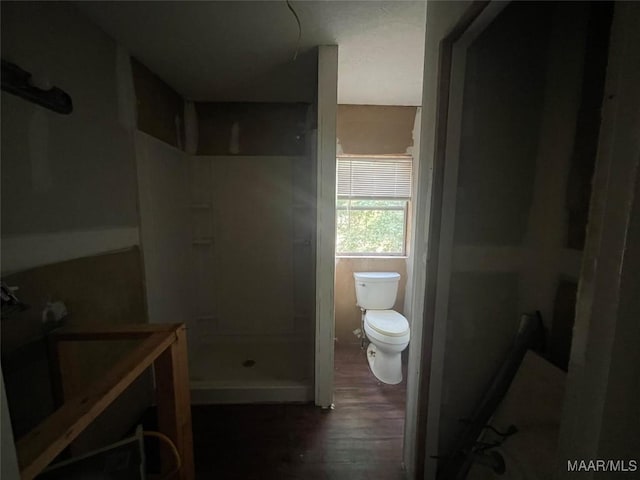 bathroom featuring hardwood / wood-style flooring, toilet, a shower, and vanity