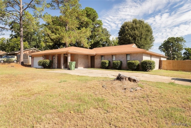 ranch-style house featuring a garage and a front yard