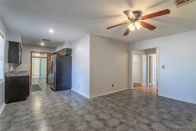 interior space featuring a textured ceiling and ceiling fan