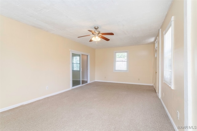 unfurnished room with a textured ceiling, ceiling fan, and carpet floors