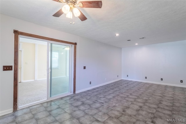 empty room featuring ceiling fan and a textured ceiling