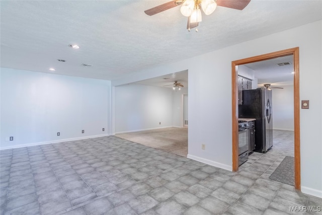 empty room featuring a textured ceiling and ceiling fan