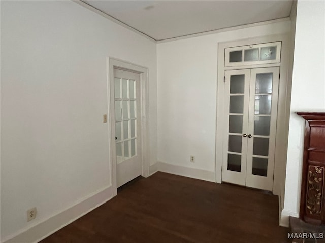 spare room featuring dark wood-type flooring and french doors