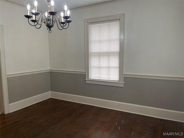 unfurnished dining area with crown molding, dark wood-type flooring, and a chandelier