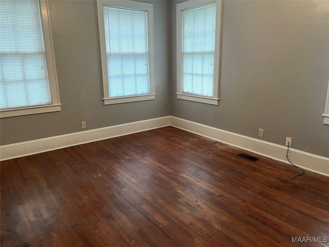 empty room with dark wood-type flooring