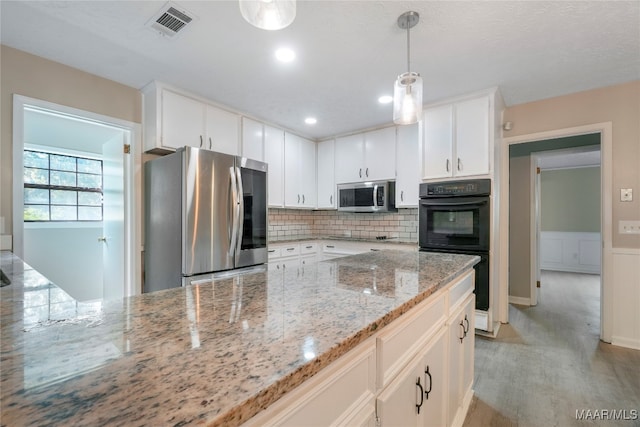 kitchen with white cabinets, light stone counters, stainless steel appliances, pendant lighting, and decorative backsplash