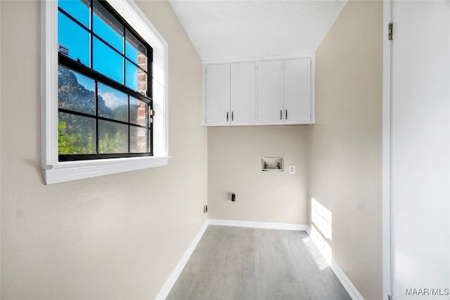 laundry area featuring washer hookup, hardwood / wood-style flooring, cabinets, and hookup for an electric dryer